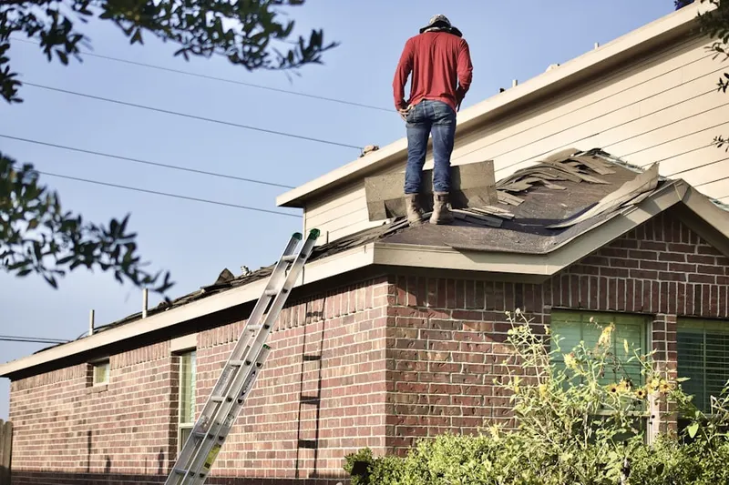 Professional roofer working on a residential roof in Rushton